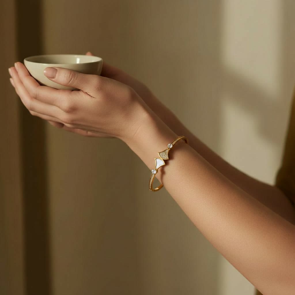 Bracelet Manchette en acier doré porté au poignet